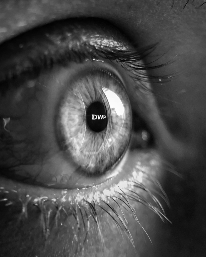 close up of an eye with DWP reflected in the iris.
